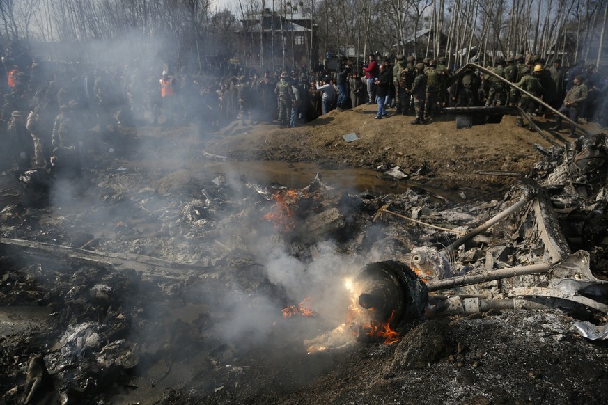 Kashmiri villagers and Indian army soldiers gather near the wreckage of an Indian aircraft after it crashed in Budgam area, outskirts of Srinagar, Indian controlled Kashmir, Wednesday, Feb.27, 2019. ( ...