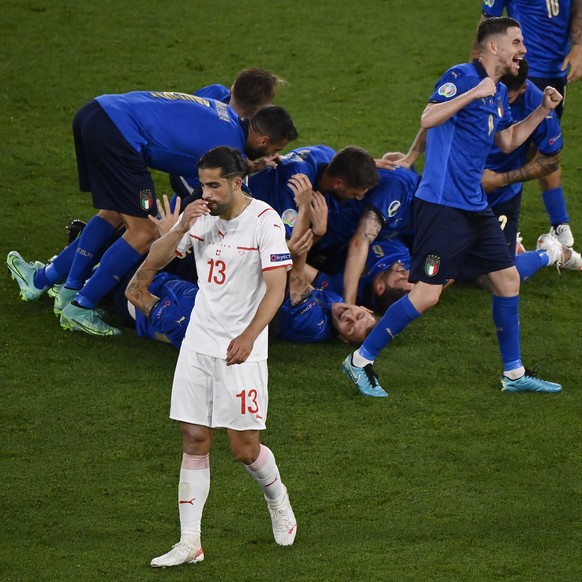 Switzerland&#039;s Ricardo Rodriguez gestures as Italy players celebrates Manuel Locatelli&#039;s second goal during the Euro 2020 soccer championship group A match between Italy and Switzerland at th ...