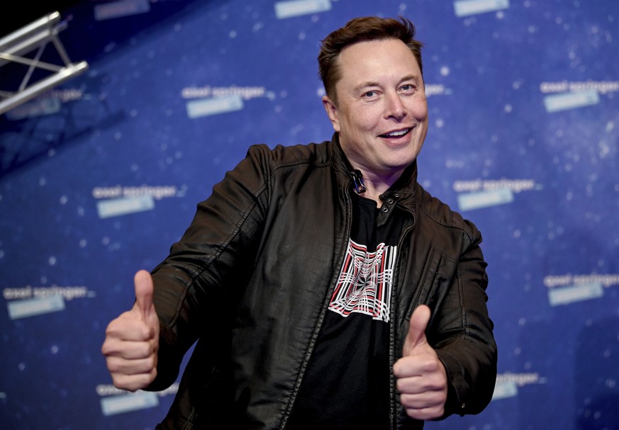 SpaceX owner and Tesla CEO Elon Musk arrives on the red carpet for the Axel Springer media award, in Berlin, Germany, Tuesday, Dec. 1, 2020. (Britta Pedersen/Pool via AP)