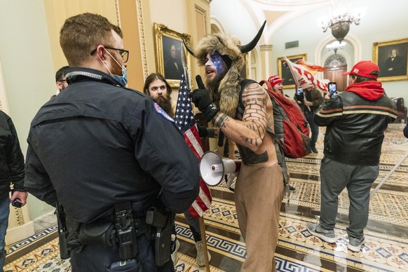 FILE - In this Jan. 6, 2021, file photo supporters of President Donald Trump are confronted by U.S. Capitol Police officers outside the Senate Chamber inside the Capitol in Washington. An Arizona man  ...