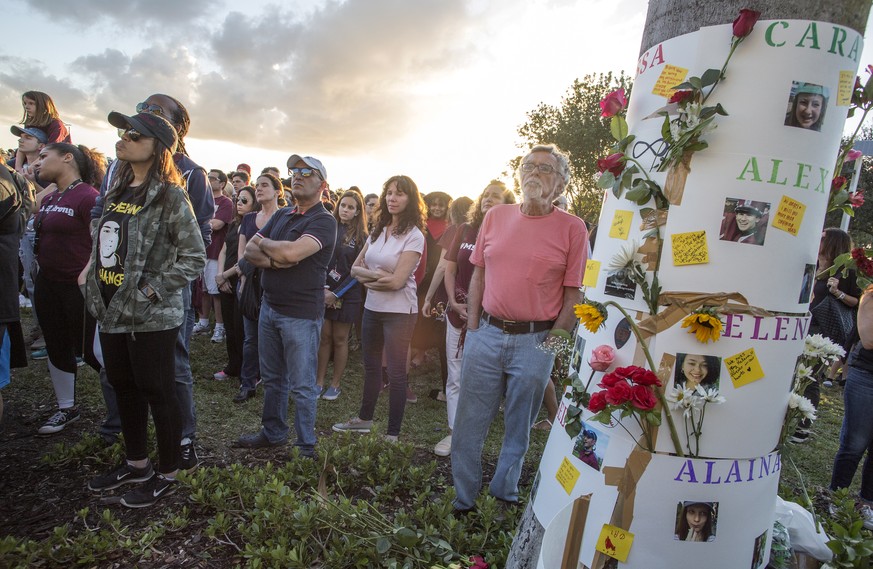 epaselect epa07371156 Community members attend to the vigil in remembrance of the victims of the Marjory Stoneman Douglas High School in Parkland, Florida, USA, 14 February 2019. Today is the 1st anni ...