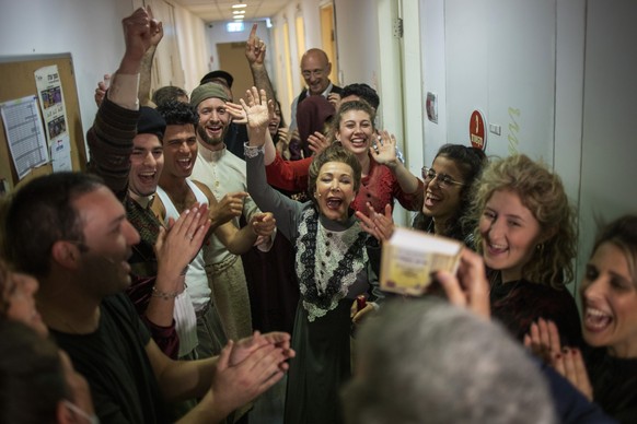Actors cheer moments before going on stage to perform in front of vaccinated spectators at Habima, Israel&#039;s national theater, in Tel Aviv, Israel, Sunday, April 4, 2021. Israel has vaccinated ove ...