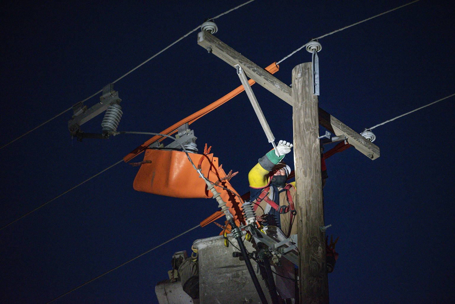 Oncor apprentice lineman Brendan Waldon repairs a utility pole that was damaged by the winter storm that passed through Texas Thursday, Feb. 18, 2021, in Odessa, Texas. (Eli Hartman/Odessa American vi ...