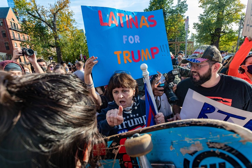 November 7, 2020, Boston, Massachusetts, USA: Supporters of President Donald Trump protest against the election result, at Biden supporters as they celebrate the result in Boston. Democrat Joe Biden d ...