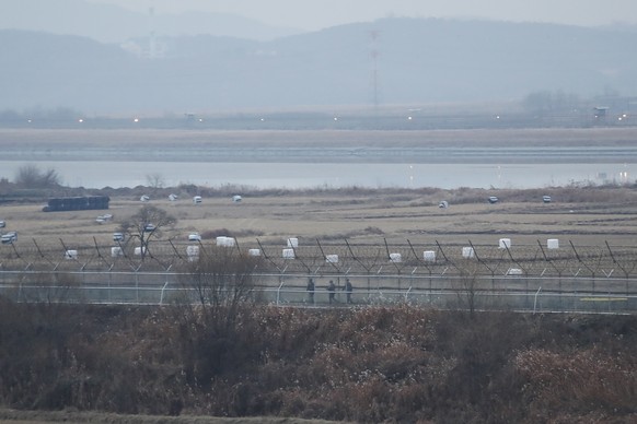 FILE - In this Dec. 16, 2019, file photo, South Korean army soldiers patrol along the barbed-wire fence in Paju, South Korea, near the border with North Korea. The Joint Chiefs of Staffs in Seoul said ...