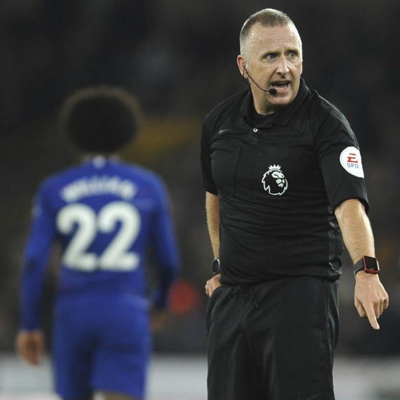 Referee Jonathan Moss gestures during the English Premier League soccer match between Wolverhampton Wanderers and Chelsea at the Molineux Stadium in Wolverhampton, England, Wednesday, Dec. 5, 2018. (A ...