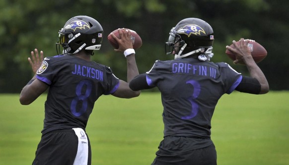 Baltimore Ravens quarterbacks Lamar Jackson (8) and Robert Griffin III (3) pass during NFL football team practice in Owings Mills, Md., Tuesday, Sept. 1, 2020. (Karl Merton Ferron/The Baltimore Sun vi ...