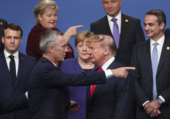 FILE - In this Dec. 4, 2019, file photo, NATO Secretary General Jens Stoltenberg, center front left, speaks with U.S. President Donald Trump, center front right, after a group photo at a NATO leaders  ...
