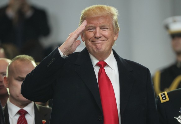 epa08656190 US President Donald J. Trump salutes from the reviewing stand during the Inaugural Parade after he was sworn in as the 45th President of the United States in Washington, DC, USA, 20 Januar ...