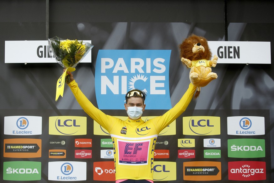 epa09063902 Swiss cyclist Stefan Bissegger of EF Education Nippo team celebrates on the podium wearing the overall leader&#039;s yellow jersey following the 3rd stage of the Paris-Nice cycling race, a ...