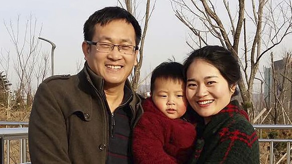 In this Feb. 2015, photo released by Li Wenzu, Wang Quanzhang, left, and his wife Li Wenzu poses for a photo with their son at a park in eastern China&#039;s Shandong province. About two dozen plaincl ...