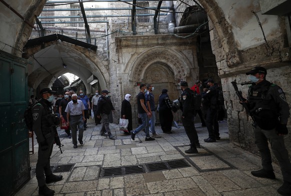 epa08767506 Palestinians making their way through the alleys of Jerusalem&#039;s Old city, to attend the Friday prayer at Al-Aqsa mosque compound , 23 October 2020. Israel began lifting of lockdown re ...