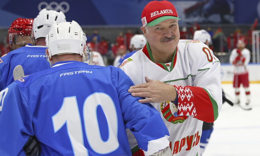 FILE In this file pool photo taken on Saturday, April 4, 2020, Belarusian President Alexander Lukashenko, right, takes part in a hockey match during Republican amateur competitions in Minsk, Belarus.  ...