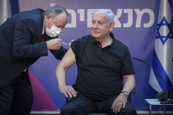 Israeli Prime Minister Minister Benjamin Netanyahu receives the second Pfizer-BioNTech COVID-19 vaccine at Sheba Medical Center in Ramat Gan, Israel, on Saturday, Jan. 9, 2021. (Miriam Elster /Pool Ph ...