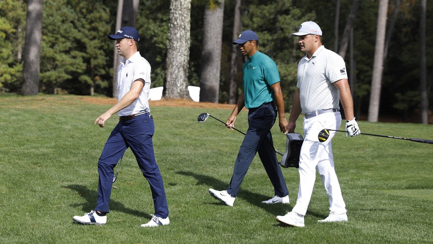epa08810295 (L-R) Justin Thomas of the US, Tiger Woods of the US and Bryson DeChambeau walk down the fairway on the fifteenth hole during the first practice round of the 2020 Masters Tournament at the ...