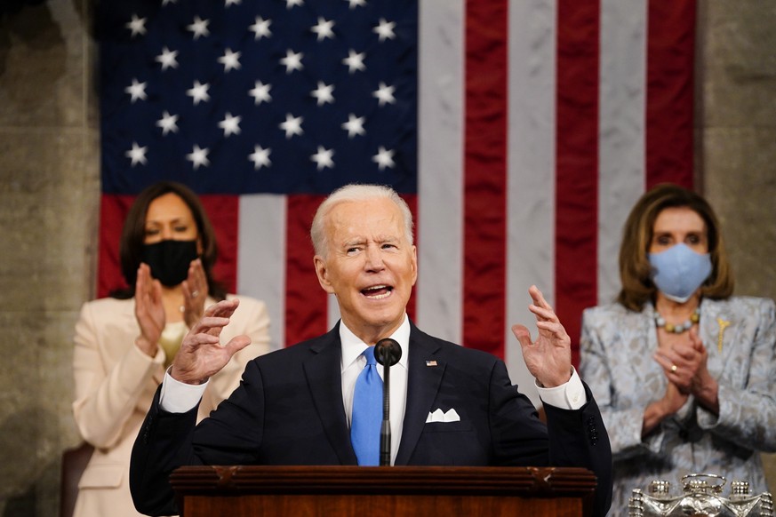 epa09166661 US President Joe Biden addresses a joint session of Congress, with Vice President Kamala Harris and House Speaker Nancy Pelosi (D-Calif.) behind him, at the Capitol in Washington, DC, USA, ...