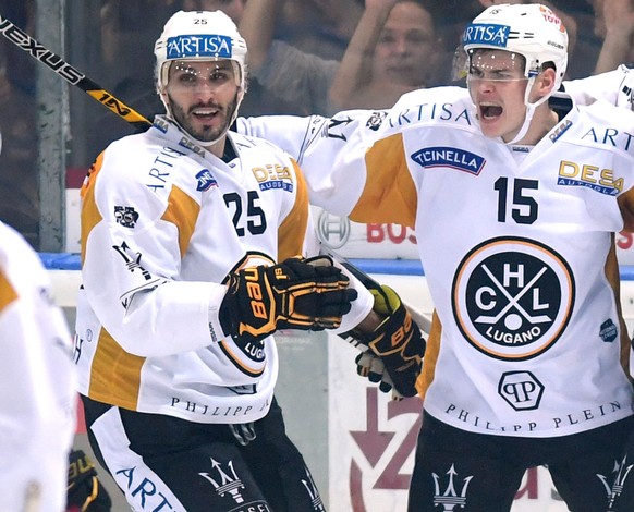 Lugano’s player Gregory Hofmann, center, celebrates the 1-2 goal with Lugano’s player Maxim Lapierre, left, and Lugano’s player Bobby Sanguinetti, right, during the preliminary round game of the Natio ...