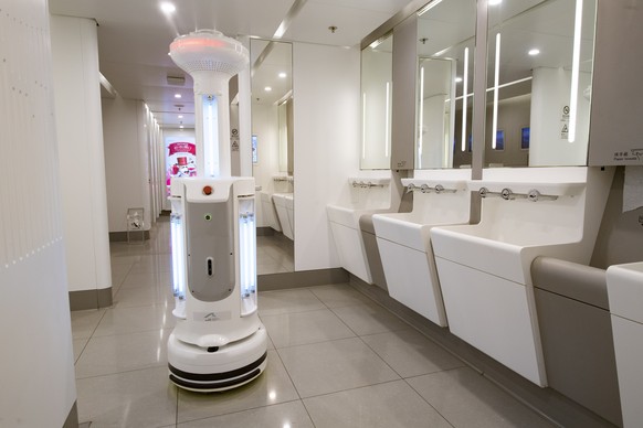 epa08387110 A handout photograph provided by Hong Kong International Airport shows an Intelligent Sterilization Robot, equipped with ultra violet light sterilizer and air sterilizer, operating in a pu ...