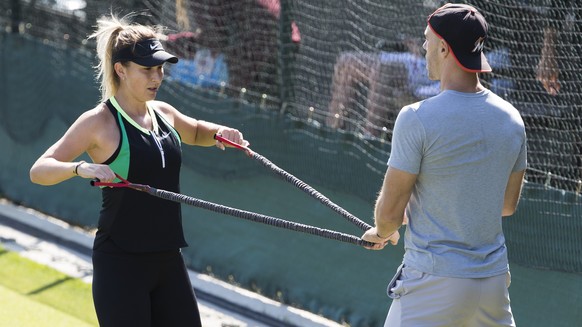Belinda Bencic of Switzerland and her fitness coach Martin Hromkovic during a training session at the All England Lawn Tennis Championships in Wimbledon, London, Wednesday, June 27, 2018. The Wimbledo ...