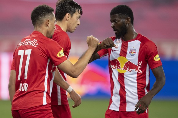 epa08463596 Salzburg&#039;s Salzburg&#039;s Noah Okafor (L) celebrates with his teammates Albert Vallci (M) and Jerome Onguene (R) after scoring on the goal for 2:0 during the Austrian first division  ...