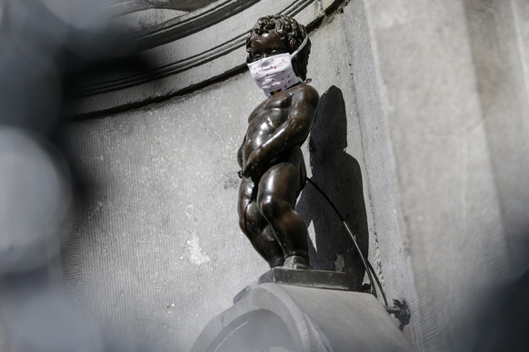 epa08426551 The Manneken Pis decorated with a face mask in Brussels, Belgium, on 16 May 2020, on the first weekend after Belgium eased lockdown measures in place to curb the spread of the COVID-19 pan ...