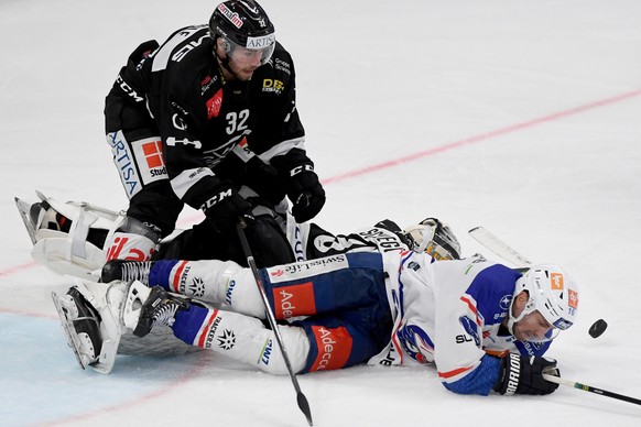From left Lugano&#039;s player Bernd Wolf, Lugano&#039;s goalkeeper Niklas Schlegel and ZSC&#039;s player Marcus Kruger, during the preliminary round game of National League A (NLA) Swiss Championship ...