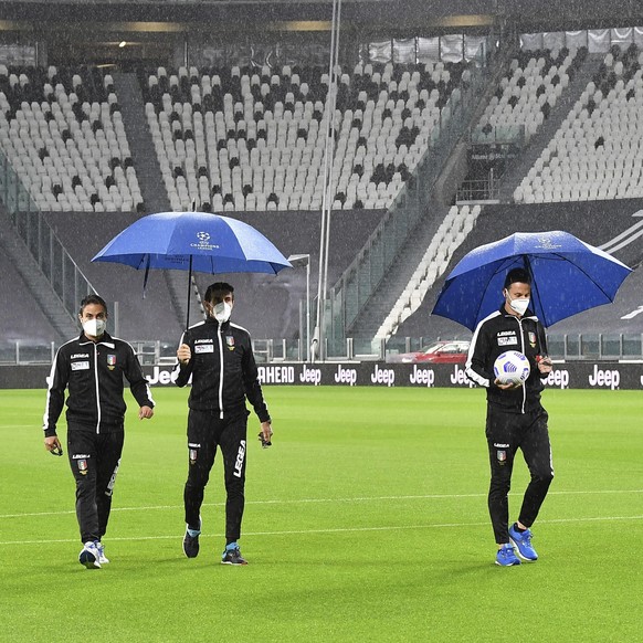 Referee Daniele Doveri, right, flanked by assistants Filippo Meli and Daniele Bindoni inspects the pitch of the Allianz Stadium in Turin, Italy, Sunday, Oct. 4, 2020 ahead of the scheduled Serie A soc ...
