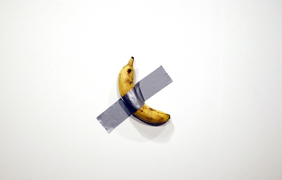 epa08047501 Italian artist Maurizio Cattelan&#039;s piece &#039;Comedian&#039; (a banana duct taped to the wall) is shown during Art Basel in Miami, Florida, USA, 05 December 2019. Art Basel represent ...