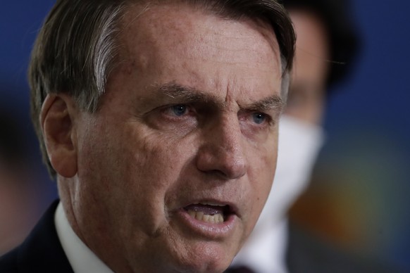 Brazilian President Jair Bolsonaro gives a press conference to announce the start of new emergency aid for the COVID-19 pandemic at Planalto presidential palace in Brasilia, Brazil, Wednesday, March 3 ...