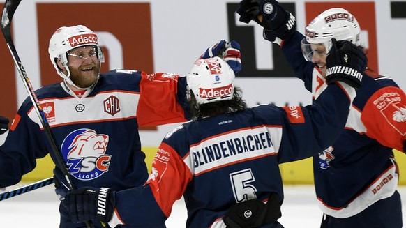 Zurich&#039;s Roman Wick, right, Severin Blindenbacher, center, and Patrick Thoresen, left, celebrate their victory in the ice hockey Champions League match 1/8 Final between ZSC Lions and HC Lugano i ...