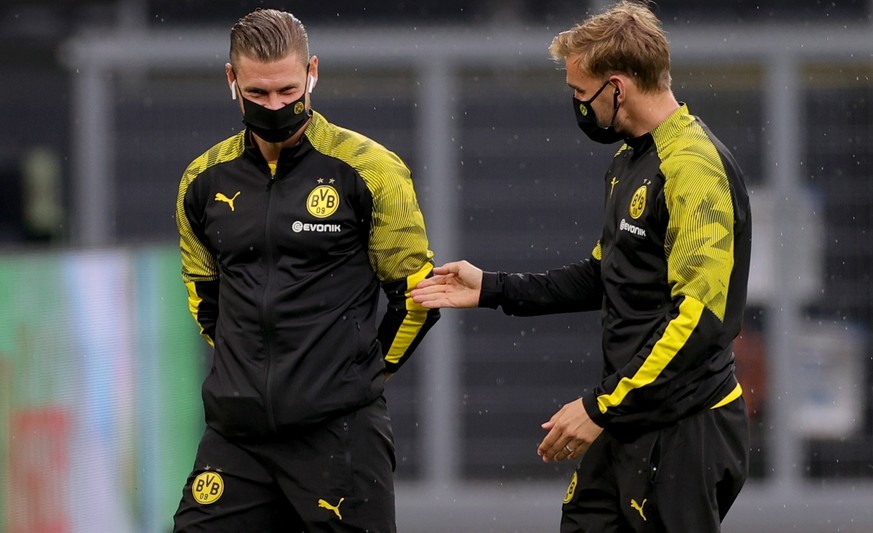 epa08491311 Lukasz Piszczek (L) and Marcel Schmelzer of Dortmund wear a face mask prior to the Bundesliga match between Borussia Dortmund and 1. FSV Mainz 05 in Dortmund, Germany, 17 June 2020. EPA/FR ...