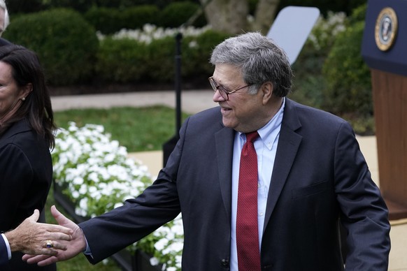 Attorney General William Barr shakes hands with someone as he departs after President Donald Trump announced Judge Amy Coney Barrett as his nominee to the Supreme Court, in the Rose Garden at the Whit ...