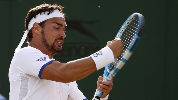 Italy&#039;s Fabio Fognini hits his racquet in frustration after losing a point to Hungary&#039;s Marton Fucsovics in a Men&#039;s singles match during day four of the Wimbledon Tennis Championships i ...