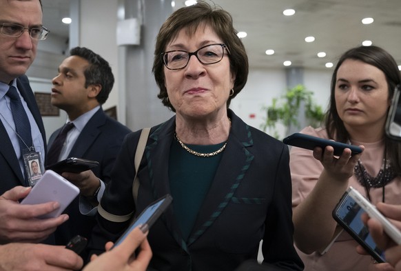 FILE - In this Feb. 12, 2020 file photo, Sen. Susan Collins, R-Maine, pauses for reporters following a vote, at the Capitol in Washington. President George W. Bush is endorsing Republican Sen. Susan C ...