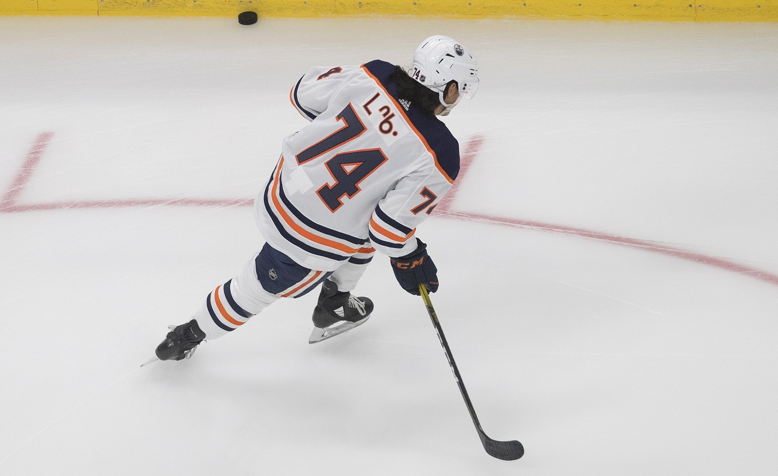 Edmonton Oilers Ethan Bear (74) wears his jersey with his name in Cree during warm up against the Calgary Flames before an exhibition NHL hockey game Tuesday, July 28, 2020 in Edmonton, Alberta. (Jaso ...
