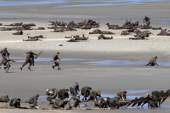 Actors perform on the beach during filming a scene for the film, &quot;Dunkirk,&quot; in Dunkirk, northern France, Thursday, May 26, 2016. The film, directed by Christopher Nolan, tells the story of t ...